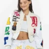 First Row Art Dealer Graphic Cropped Cream Varsity Jacket